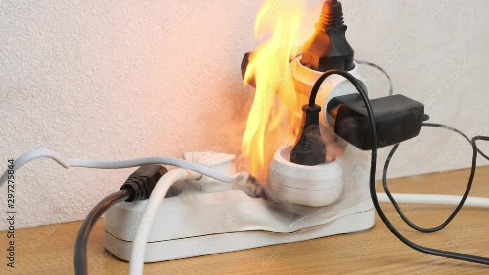 Ignition of overloaded power strip on desk in office. fire from power sockets.
