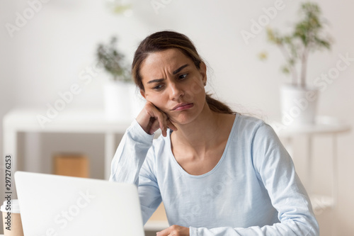 Unhappy stressed young mixed race woman stuck with hard task. photo