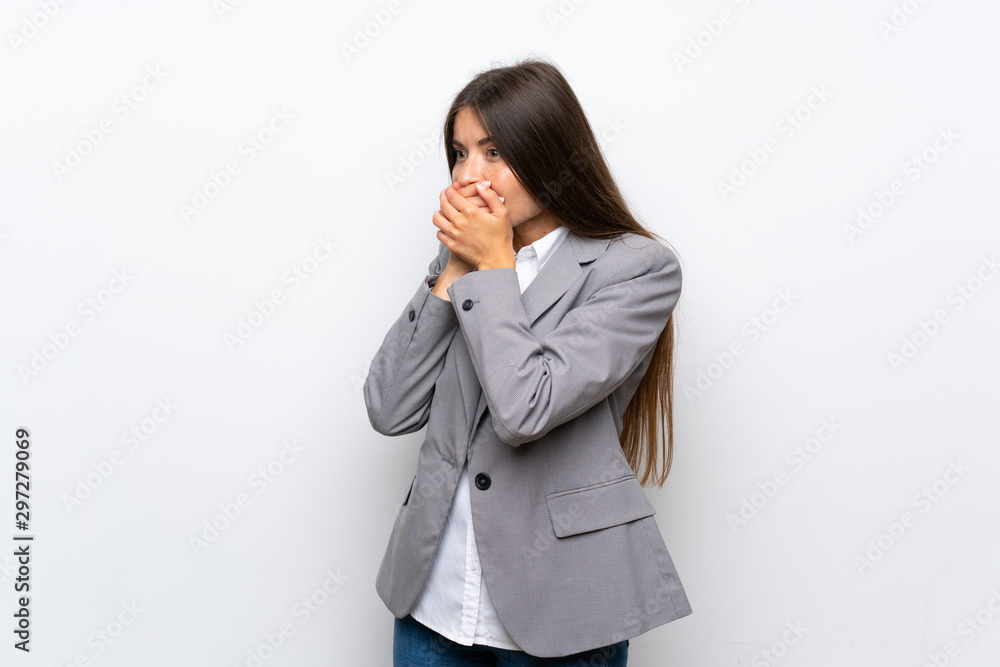 Young business woman over isolated white background covering mouth and looking to the side Young business woman over isolated white background covering mouth and looking to the side