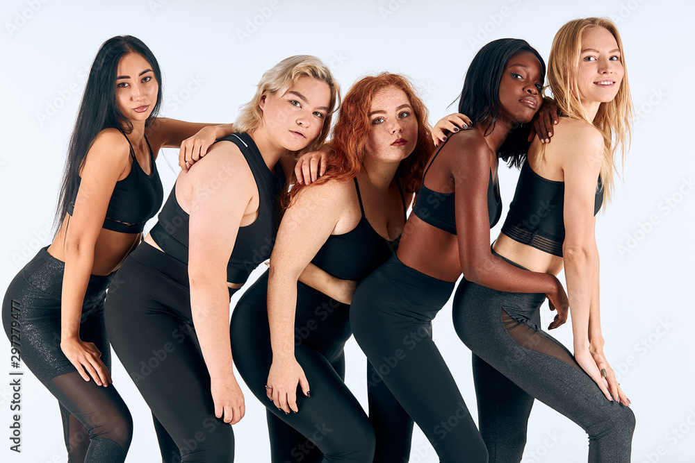 Young models of different sizes, nationalities, hairs. Model plus size, slim girls isolated over white background Young models of different sizes, nationalities, hairs. Model plus size, slim girls isolated over white background