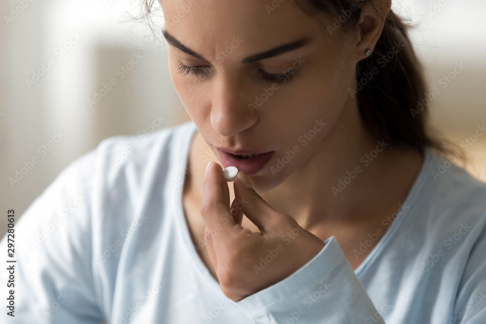 Millennial lady taking vitamins medicine, antidepressant, painkiller. Millennial lady taking vitamins medicine, antidepressant, painkiller.