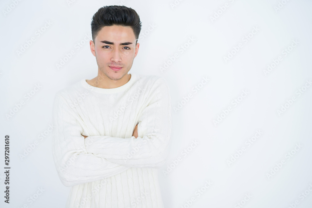 Handsome young man over white isolated background skeptic and nervous, disapproving expression on face with crossed arms. Negative person. Handsome young man over white isolated background skeptic and nervous, disapproving expression on face with crossed arms. Negative person.