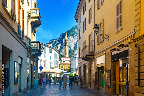 Lecco street with bell-tower of Basilica photo