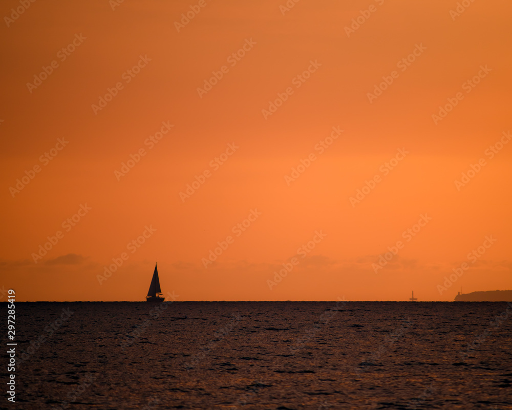 silhouette of sail ship in sunset