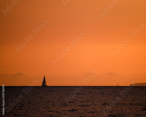 silhouette of sail ship in sunset