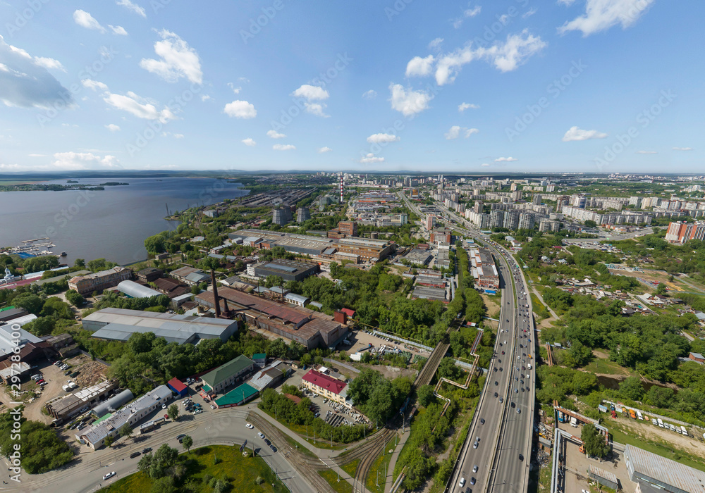 Summer city and road with cars, a lot of trees, aerial view. Industrial Zone and pond. Ekaterinburg, Verkh-Isetsky district, Russia