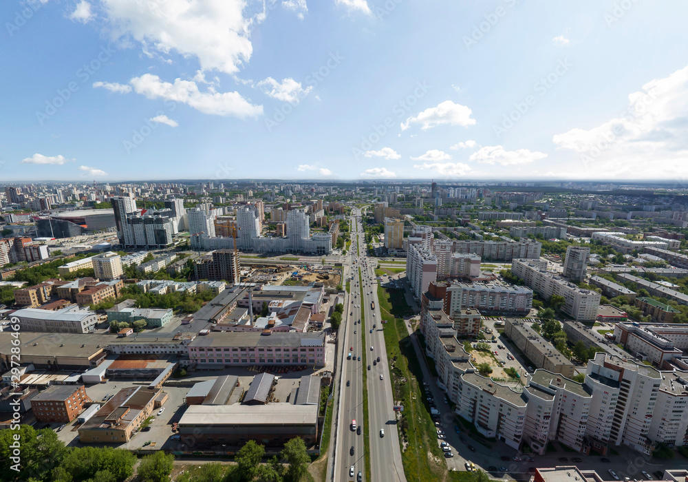 Fototapeta premium Summer city, road with cars and industrial zone, aerial view. Ekaterinburg, Verkh-Isetsky district, Russia