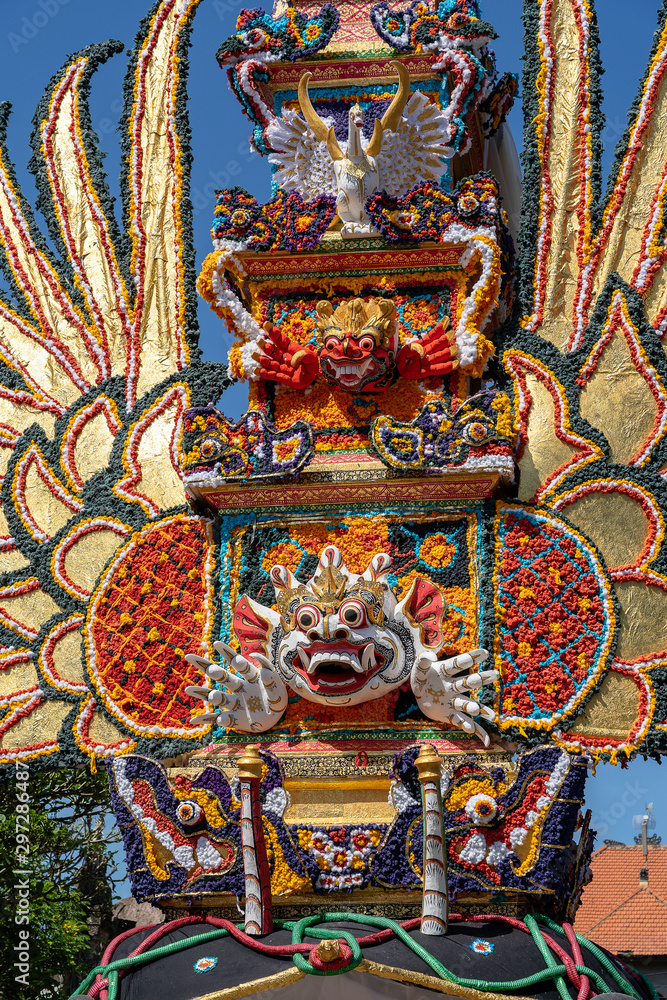 Bade cremation tower with traditional balinese sculptures of demons and flowers on central street in Ubud, Island Bali, Indonesia . Prepared for an upcoming cremation ceremony