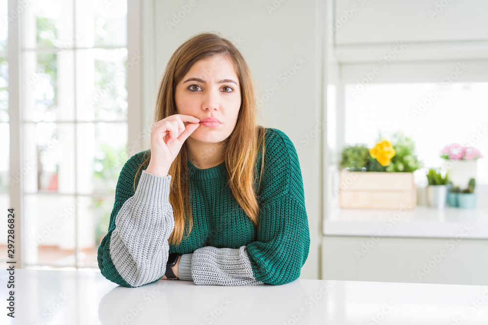 Young beautiful plus size woman wearing casual striped sweater mouth and lips shut as zip with fingers. Secret and silent, taboo talking Young beautiful plus size woman wearing casual striped sweater mouth and lips shut as zip with fingers. Secret and silent, taboo talking