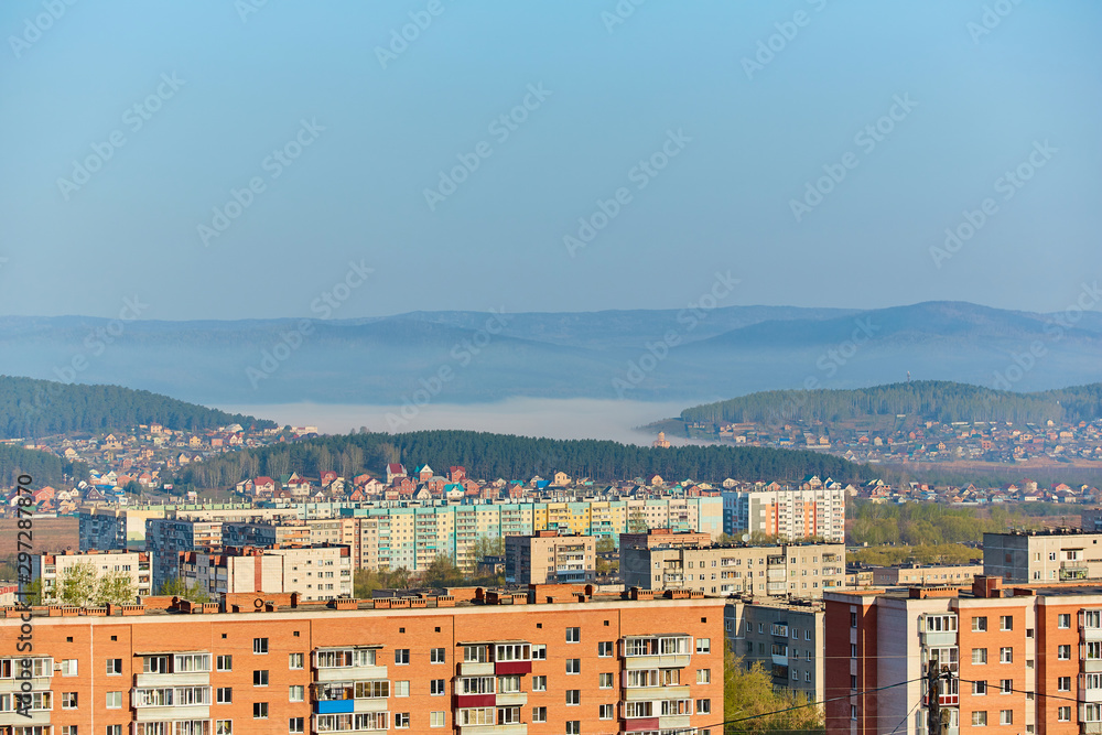 Residential complex in the Northern part of Miass, Russia. In the background, the Ural mountains, Ilmen ridge and the village of Turgoyak, near lake Turgoyak