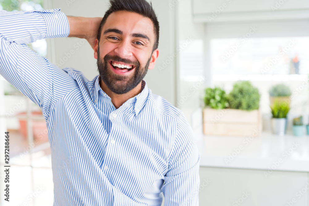 Handsome man smiling cheerful with a big smile on face showing teeth, positive and happy expression Handsome man smiling cheerful with a big smile on face showing teeth, positive and happy expression