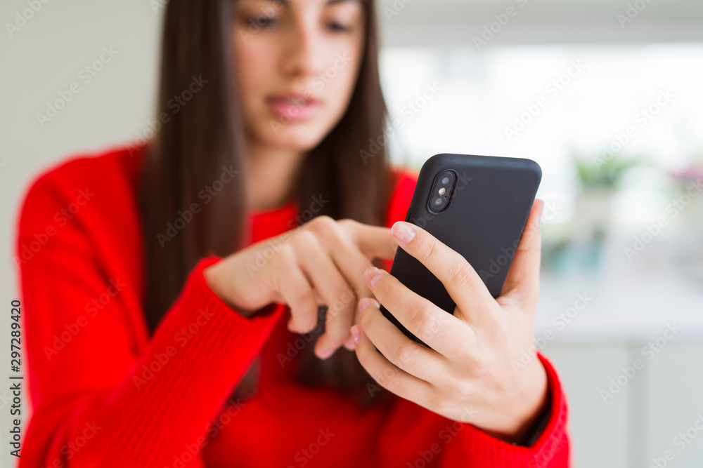 Young woman using smartphone, smiling happy texting and typing Young woman using smartphone, smiling happy texting and typing
