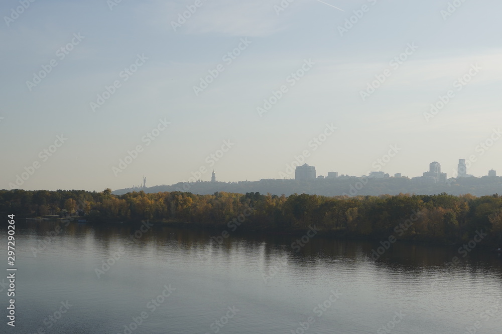 View of the river and the autumn forest, in the distance you can see the city of Kiev.