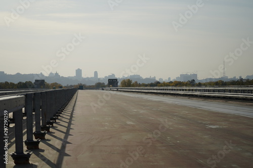 Unfinished bridge against the background of the silhouette of the city. Unfinished highway away city. Fender on the autobahn