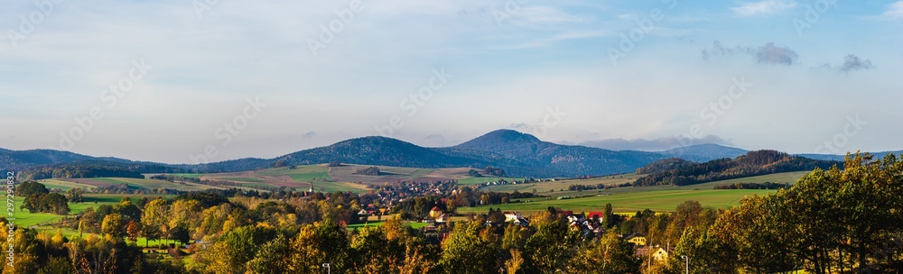 panoramic autumn view on Lusatian Mountains with the villages Hoernitz and Bertsdorf in the foreground and Mount Lausche in the background as seen from Zittau