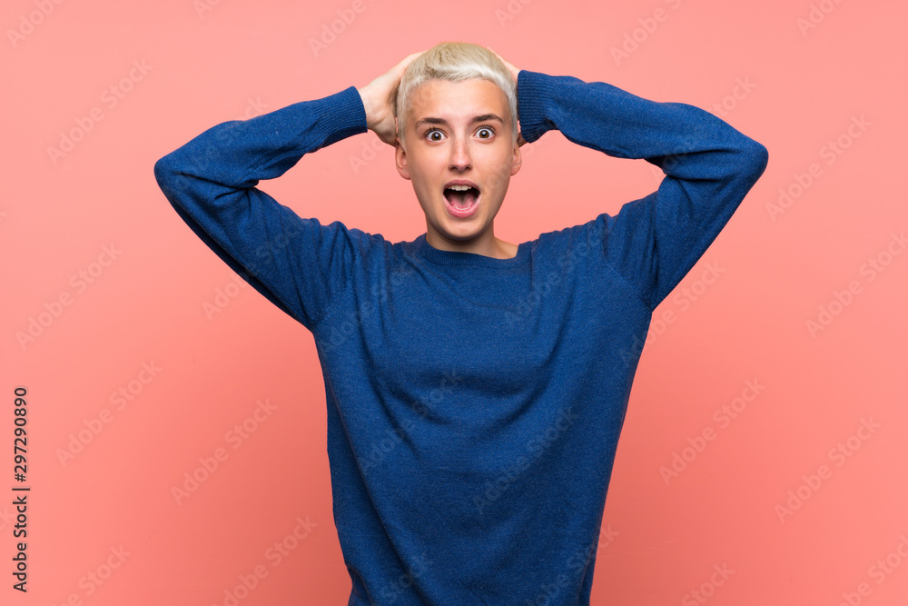 Teenager girl with white short hair over pink wall frustrated and takes hands on head Teenager girl with white short hair over pink wall frustrated and takes hands on head