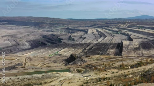 Aerial view of huge open pit brown coal mine (lignite coal quarry), fossil fuel open-cast mining facility - landscape panorama of Turow from above, Bogatynia, Poland, Europe photo