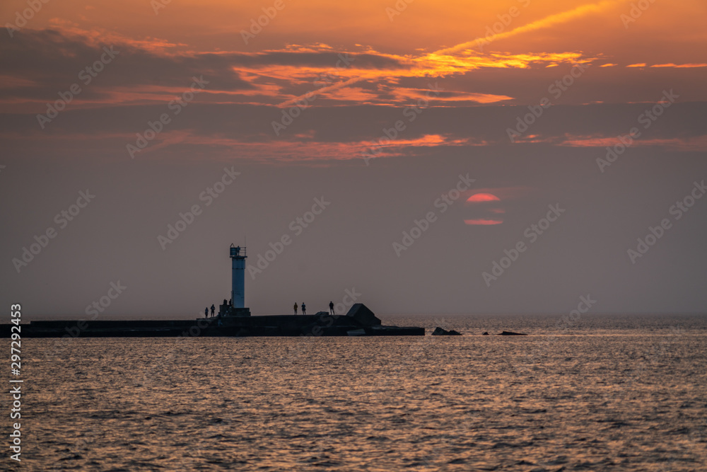 Beautiful sunset over the small lighthouse