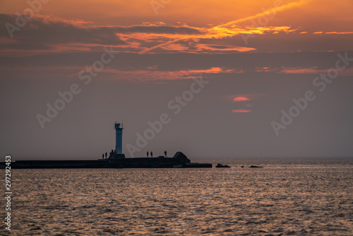 Beautiful sunset over the small lighthouse