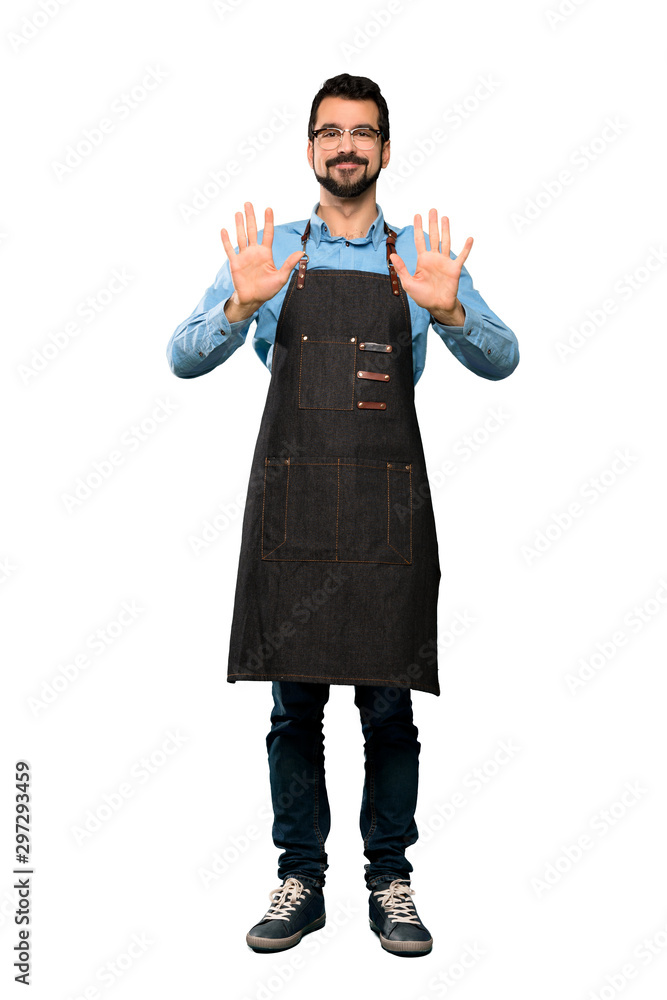 Full-length shot of Man with apron counting ten with fingers over isolated white background Full-length shot of Man with apron counting ten with fingers over isolated white background