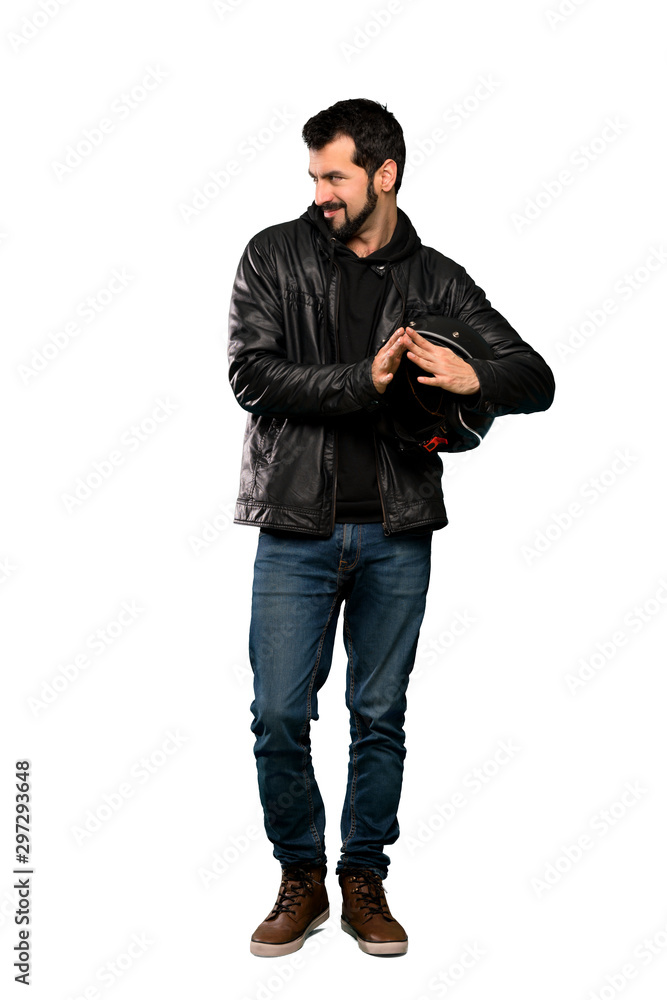 Full-length shot of Biker man scheming something over isolated white background Full-length shot of Biker man scheming something over isolated white background