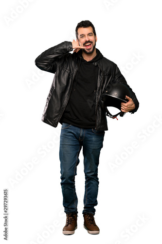 Full-length shot of Biker man making phone gesture. Call me back sign over isolated white background