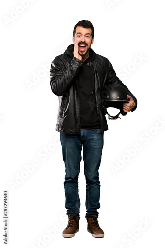 Full-length shot of Biker man shouting and announcing something over isolated white background
