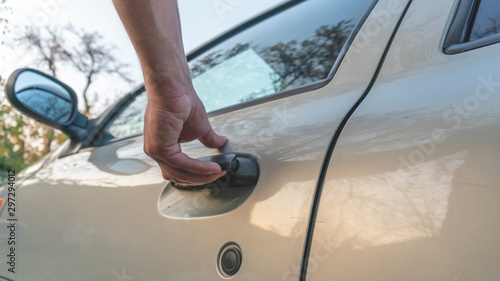 hand opens the car door