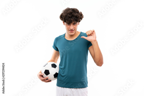 Young football player man over isolated white wall proud and self-satisfied © luismolinero
