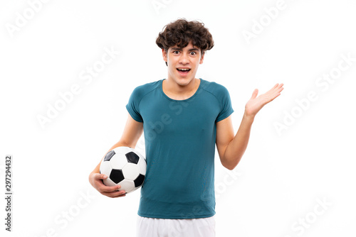 Young football player man over isolated white wall with shocked facial expression © luismolinero