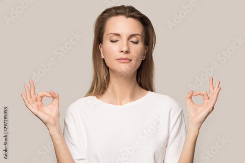 Calm young woman meditate with eyes closed