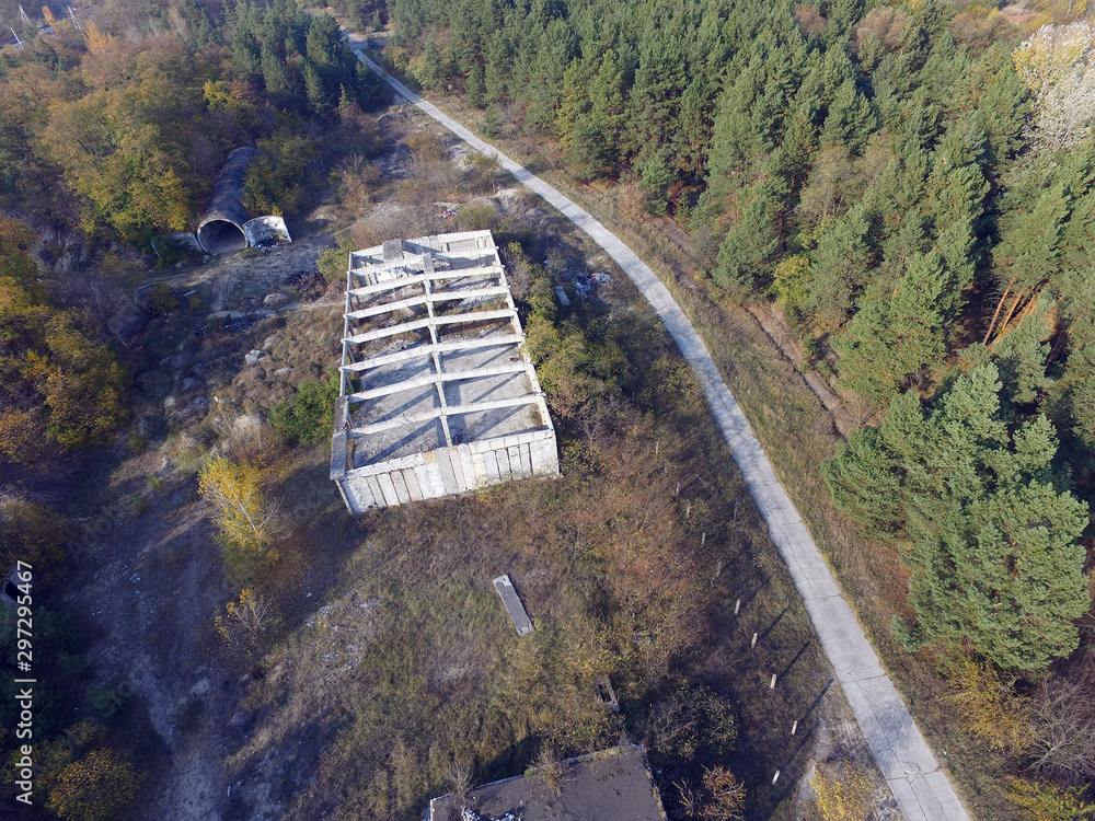 Fototapeta premium Drone quadrocopter explores an abandoned totally marauded and vandalised Soviet military base. Near Chernobyl Area. 