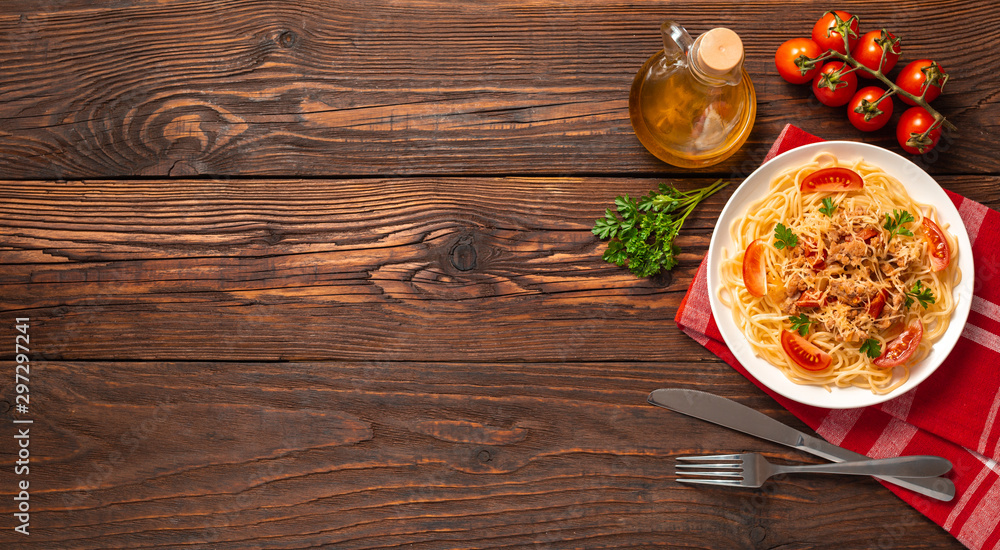 Pasta bolognese with tomato sauce and minced meat, grated parmesan cheese and fresh parsley - homemade healthy italian pasta on rustic wooden background. Flat lay. Top view. Pasta bolognese with tomato sauce and minced meat, grated parmesan cheese and fresh parsley - homemade healthy italian pasta on rustic wooden background. Flat lay. Top view.