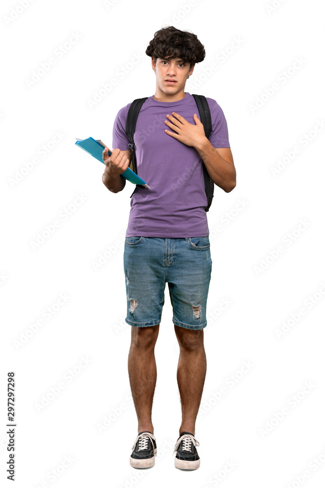 A full-length shot of a Young student man surprised and shocked while looking right over isolated white background A full-length shot of a Young student man surprised and shocked while looking right over isolated white background