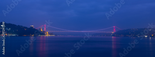 Panoramic dawn at Fatih Sultan Mehmet Bridge. Dark blue sky and lights reflected in the sea Bosphorus -, Turkey