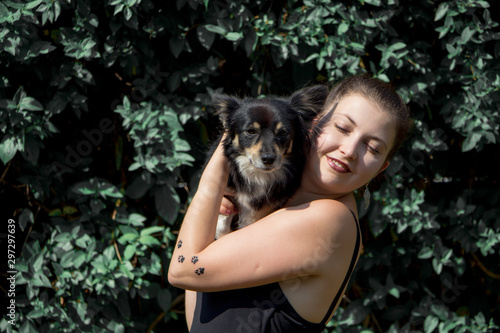 Portrait of happy young woman with her cute dog