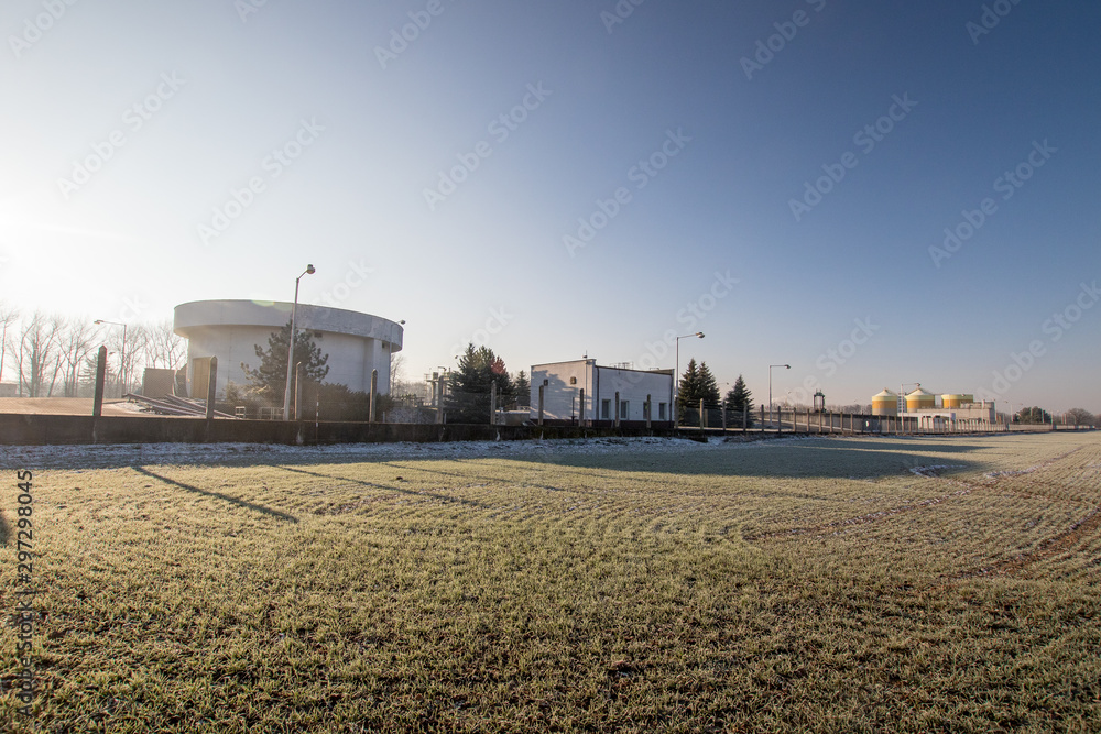 frozen field with industry buildings