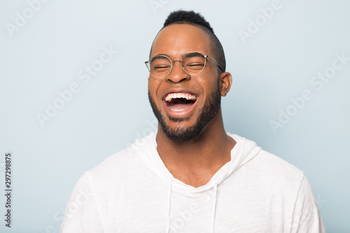 Overjoyed african American man laugh at funny joke