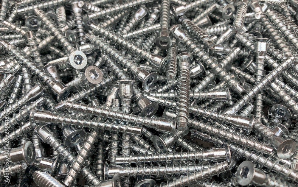 Mounts for cabinet furniture. Coupling element for connecting parts. Screws for the background. Mounts for cabinet furniture. Coupling element for connecting parts. Screws for the background.