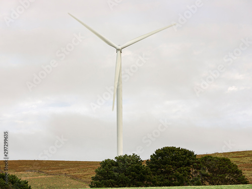 A large wind turbine moving to create kinetic energy for renewable energy supply on a cloudy day located southeast of Lake George and north of Bungendore in New South Wales, Australia 