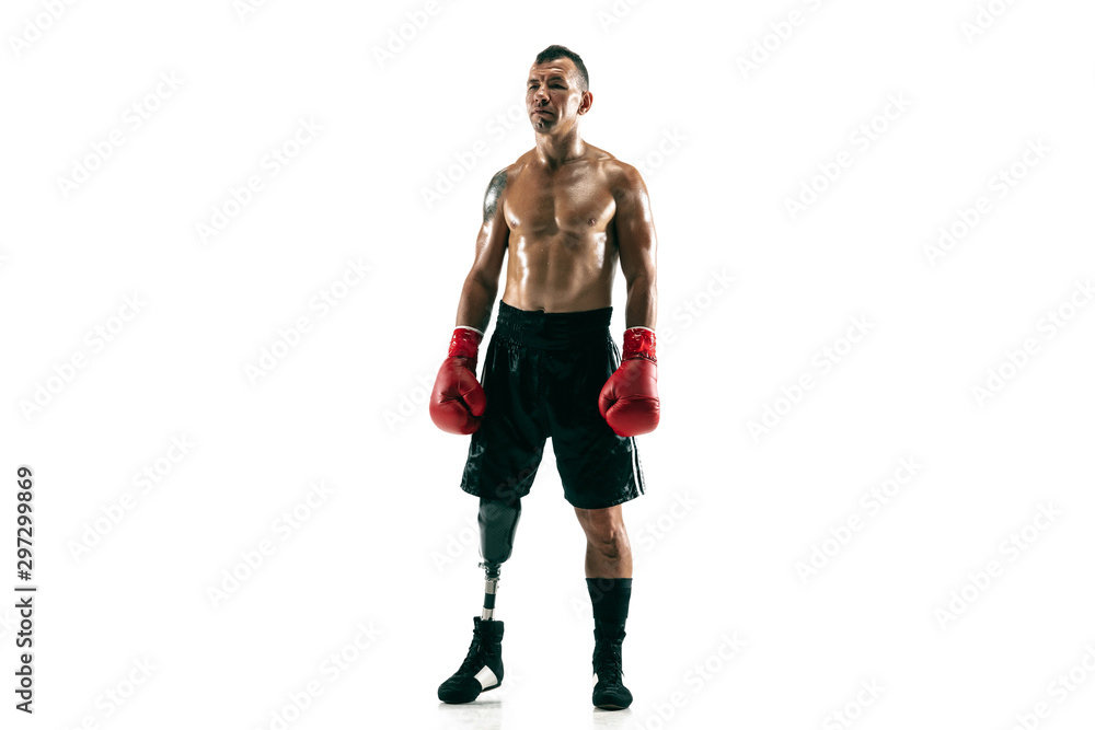 Full length portrait of muscular sportsman with prosthetic leg, copy space. Male boxer in red gloves. Isolated shot on white studio background. Full length portrait of muscular sportsman with prosthetic leg, copy space. Male boxer in red gloves. Isolated shot on white studio background.
