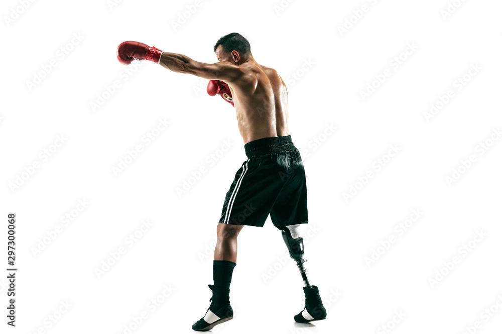 Full length portrait of muscular sportsman with prosthetic leg, copy space. Male boxer in red gloves. Isolated shot on white studio background. Full length portrait of muscular sportsman with prosthetic leg, copy space. Male boxer in red gloves. Isolated shot on white studio background.