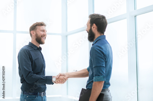 business people shaking hands in a bright office