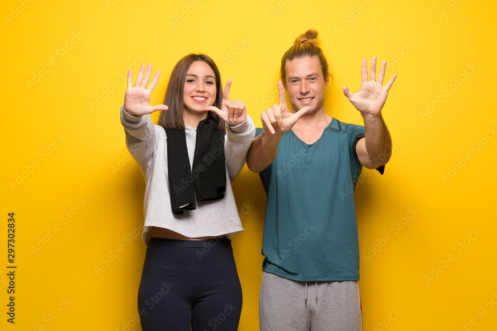 Group of athletes over yellow background counting seven with fingers Group of athletes over yellow background counting seven with fingers