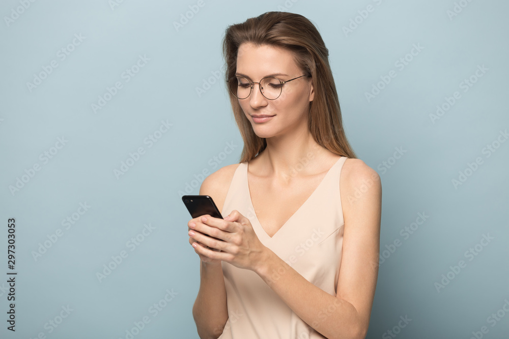 Millennial woman in glasses busy using modern smartphone Millennial woman in glasses busy using modern smartphone
