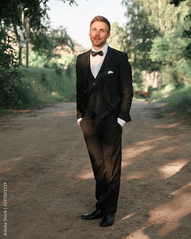 groom in a wedding suit on the background of nature. groom in a wedding suit on the background of nature.