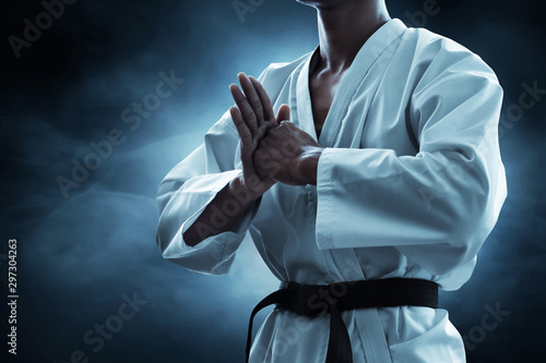 Karate martial arts fighter on dark background photo