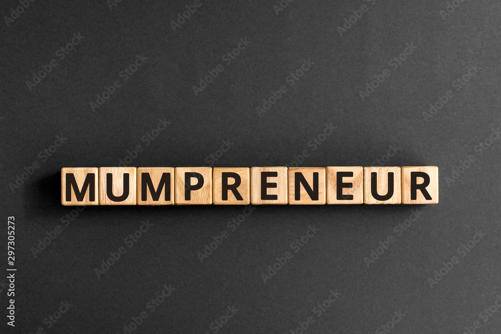 Mumpreneur - word from wooden blocks with letters, mother who has started her own business concept, top view on grey background Mumpreneur - word from wooden blocks with letters, mother who has started her own business concept, top view on grey background