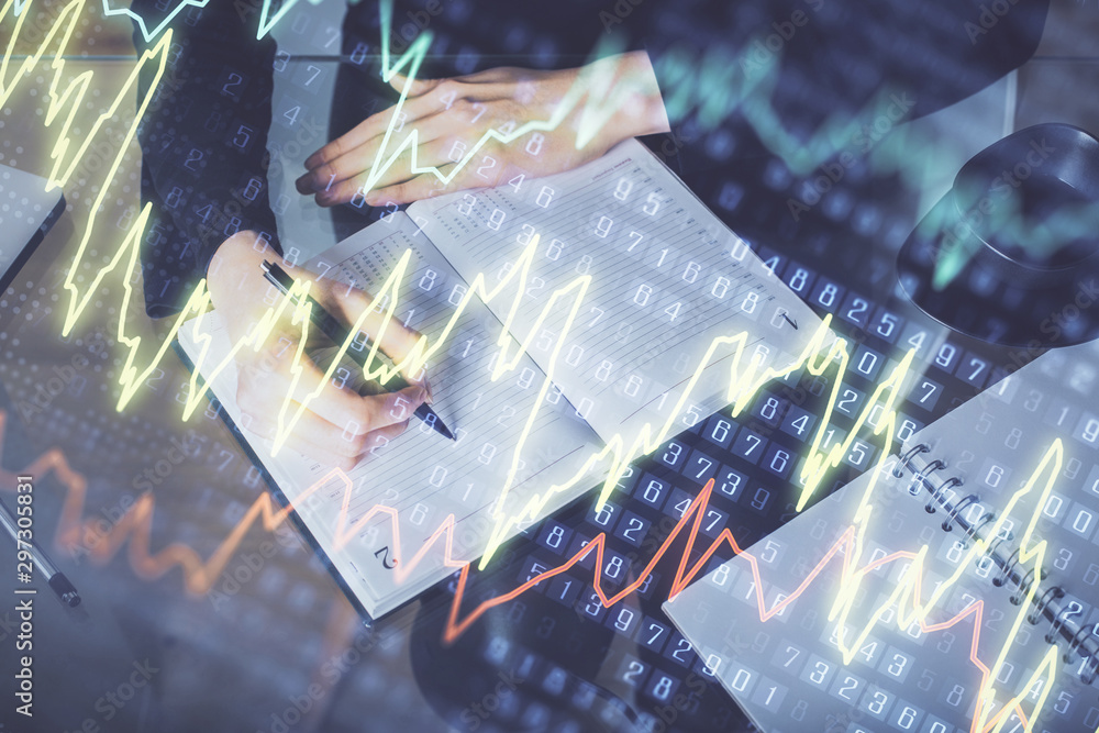 Forex chart hologram on hand taking notes background. Concept of analysis. Multi exposure Forex chart hologram on hand taking notes background. Concept of analysis. Multi exposure
