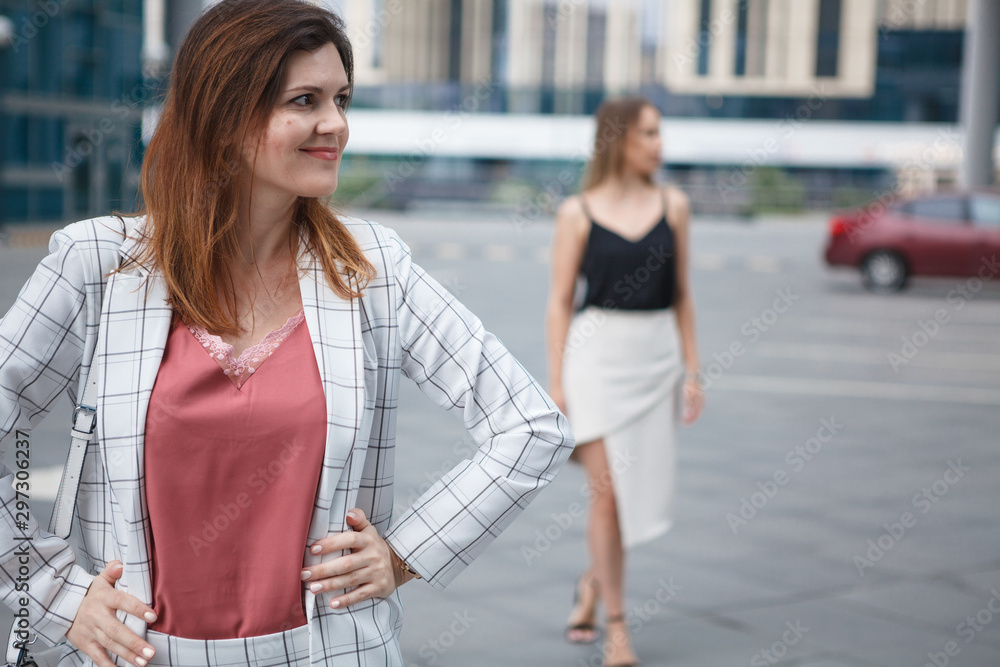 Young beautiful woman on her girlfriend background Young beautiful woman on her girlfriend background